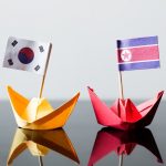 flags of southkorea and northkorea in paper ships