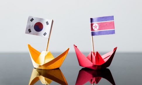 flags of southkorea and northkorea in paper ships